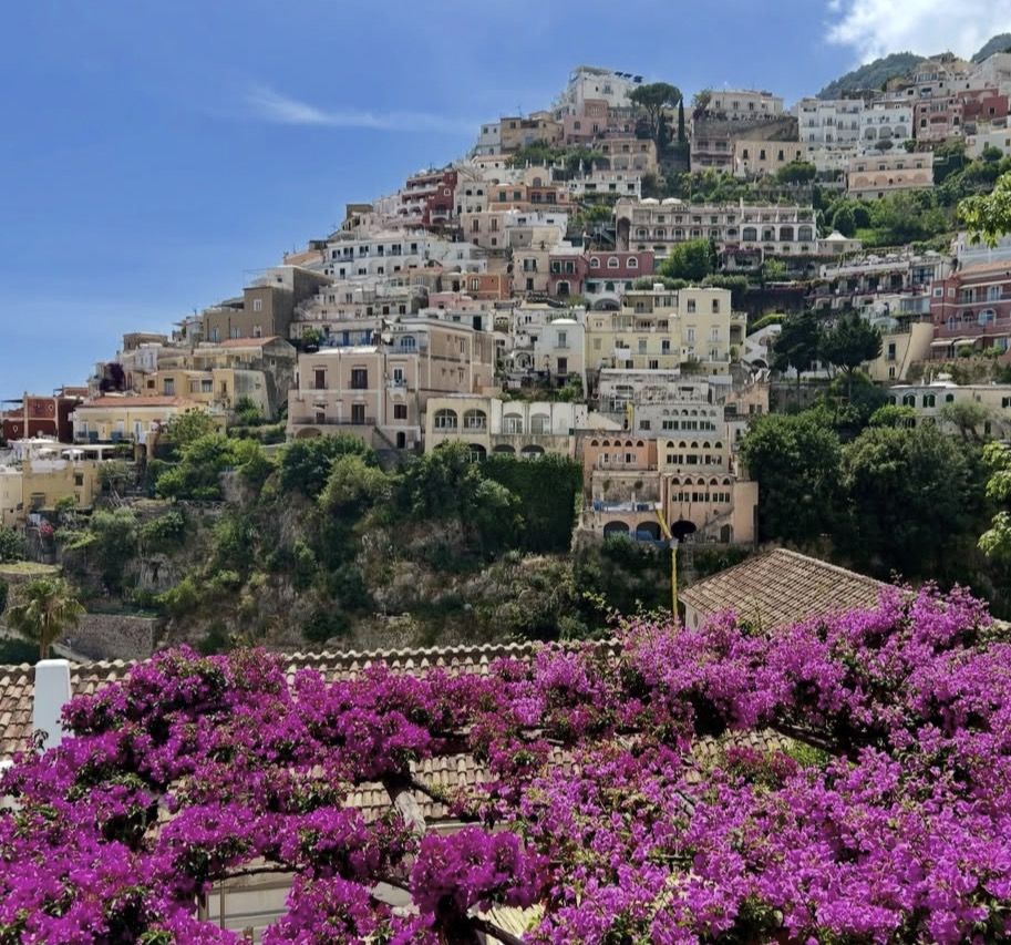 Ferry arriving at Amalfi harbour with the town's cathedral and cliffs visible in the background